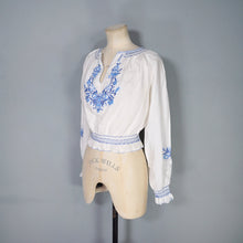 Load image into Gallery viewer, 70s WHITE HUNGARIAN FOLK BLOUSE WITH BLUE FLORAL EMBROIDERY - S