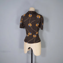 Load image into Gallery viewer, 70s BROWN ART DECO LADY AMULET PRINT PUFF SLEEVE SHIRT - L