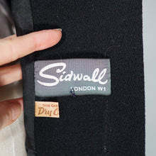 Load image into Gallery viewer, 60s BLACK WOOL COAT BY SIDWALL WITH CELTIC BUCKLE AND SHEEPSKIN HOOD - M