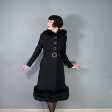Load image into Gallery viewer, 60s BLACK WOOL COAT BY SIDWALL WITH CELTIC BUCKLE AND SHEEPSKIN HOOD - M