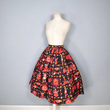Load image into Gallery viewer, 50s NOVELTY SKIRT IN BLACK AND RED WITH ORNAMENT / FIGURINE PRINT - 26&quot;