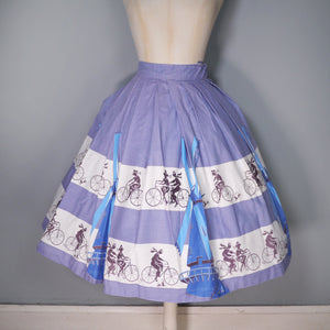 50s LIGHT BLUE NOVELTY SKIRT WITH DUTCH WINDMILLS AND CYCLISTS - 26"