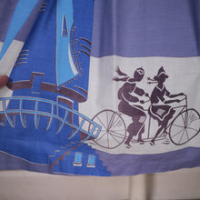 Load image into Gallery viewer, 50s LIGHT BLUE NOVELTY SKIRT WITH DUTCH WINDMILLS AND CYCLISTS - 26&quot;