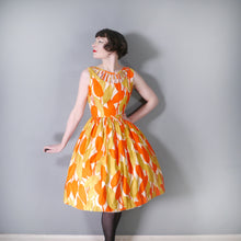Load image into Gallery viewer, 50s LADDER CUT OUT NECKLINE ORANGE AND GREEN-YELLOW ABSTRACT PRINT DAY DRESS - S