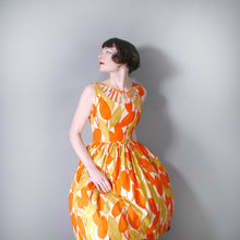 Load image into Gallery viewer, 50s LADDER CUT OUT NECKLINE ORANGE AND GREEN-YELLOW ABSTRACT PRINT DAY DRESS - S