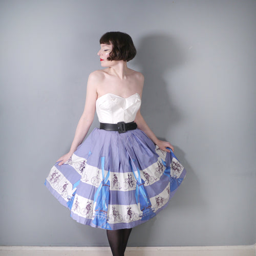 50s LIGHT BLUE NOVELTY SKIRT WITH DUTCH WINDMILLS AND CYCLISTS - 26
