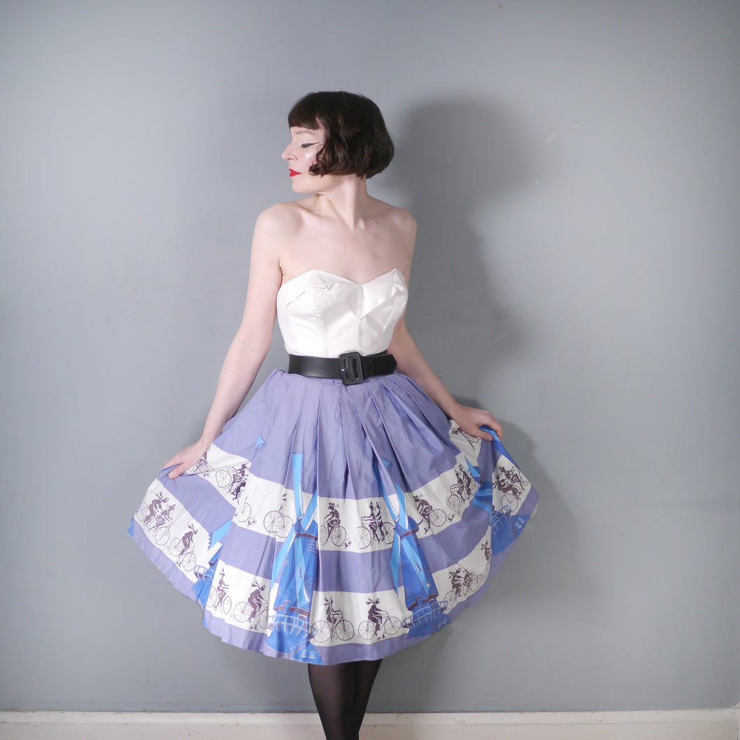 50s LIGHT BLUE NOVELTY SKIRT WITH DUTCH WINDMILLS AND CYCLISTS - 26