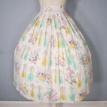 Load image into Gallery viewer, 50s PASTEL NOVELTY SKIRT WITH BUTTERFLIES, MANDOLINS AND FRUIT BASKETS - 24&quot;