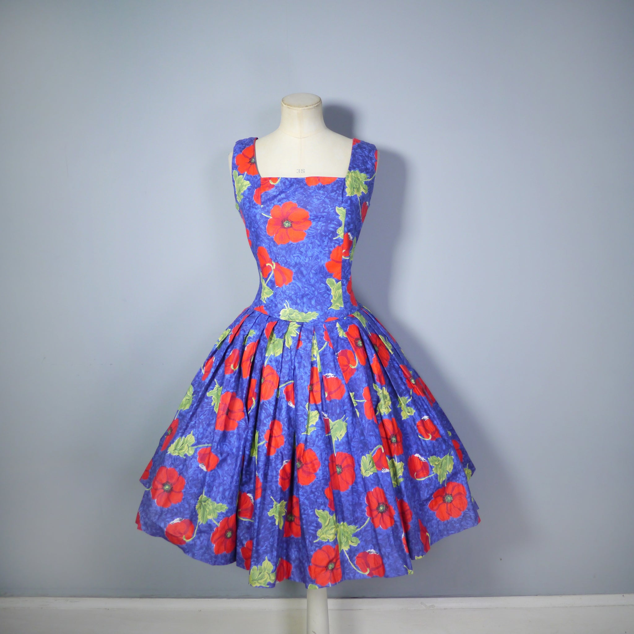 Blue dress shop with red poppies